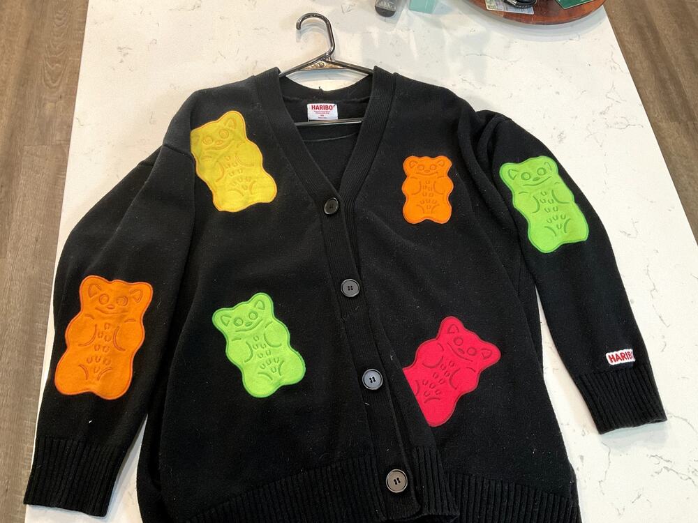 black knit Haribo cardigan featuring colorful gummy bear appliqués.